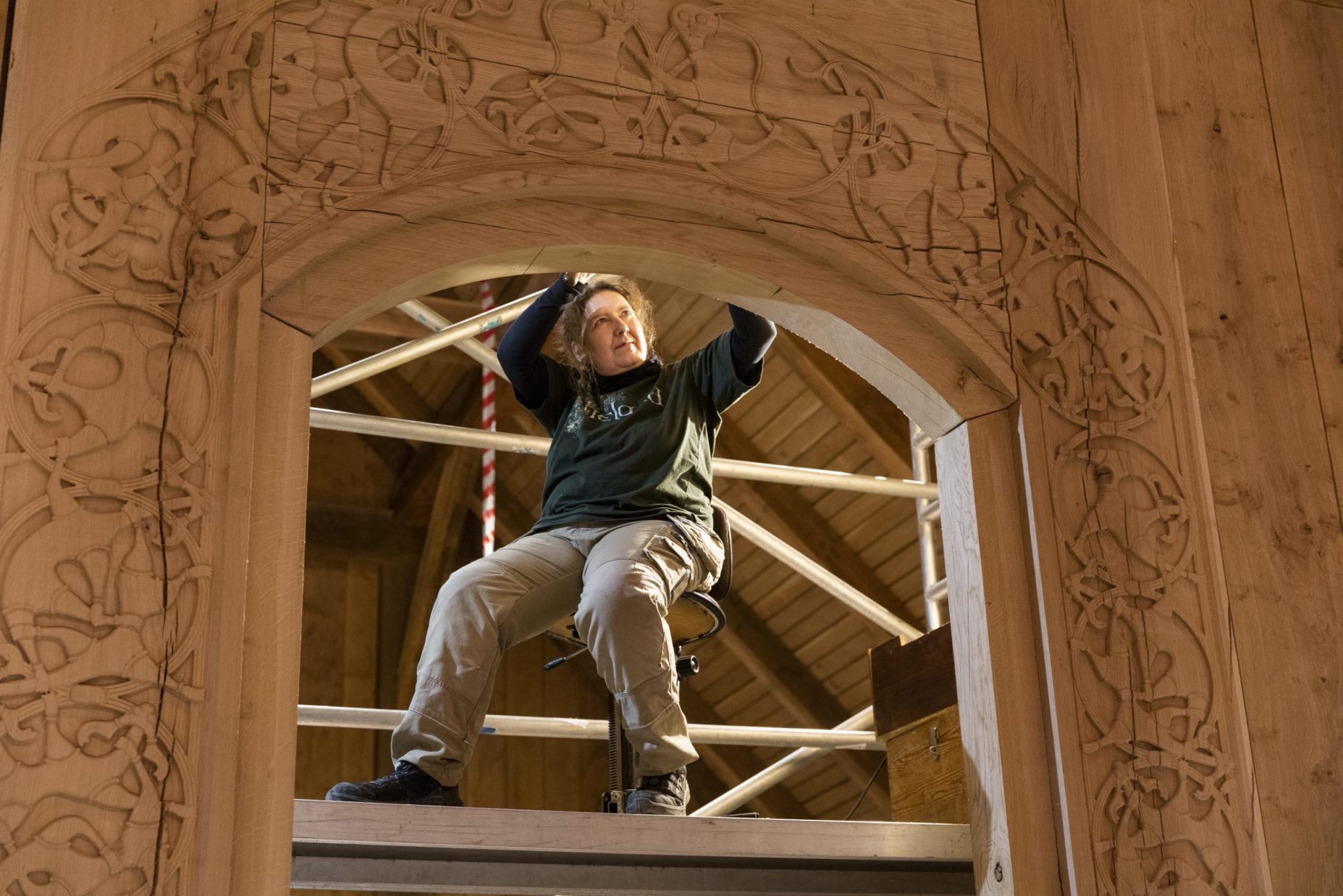 CNC-finished door portal of Denmark's largest Viking king’s hall, showcasing intricate dragon-scale carvings